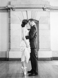 a bride and groom standing in front of a doorway