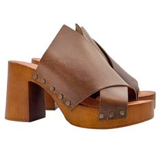 "In a woman's wardrobe, heeled sandals cannot be missing, which give that touch of style that a woman needs. The wide heel and the plateau of our clogs offer incredible comfort, slender your figure, with minimal effort. Women's clogs with brown wood effect base Upper in brown leather, with wide crossed band Soft padded insole Open toe 8.5 cm wide heel and 3 cm plateau Entirely made by specialized Italian personnel Handcrafted using the best materials. Designed & Produced By \"MY Clogs\" BEFORE P Chic Brown Cross Strap Sandals, Wedge Sandals With Wooden Block Heel In Medium Width, Wedge Sandals With Wooden Block Heel, Wedge Sandals With Wooden Heel And Medium Width, Chic Clogs With Open Heel In Medium Width, Spring Clogs With Wrapped Heel And Round Toe, Medium Width Wedge Sandals With Wooden Heel, Chic Open Heel Clogs Medium Width, Brown Sandals With Reinforced Heel And Medium Width