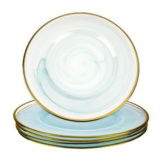 three plates stacked on top of each other with gold rims and blue swirl designs