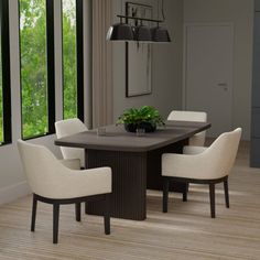 a dining room table with white chairs around it