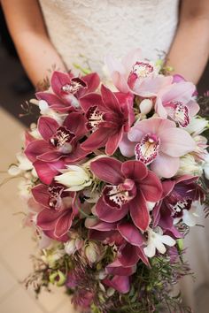 a bride holding a bouquet of flowers in her hands