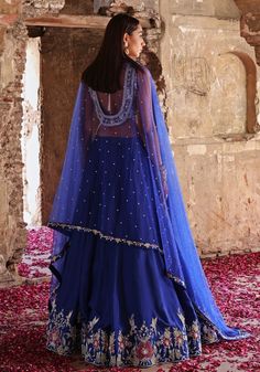 Elevate your style with Blue Embroidered Silk Lehenga Set. Crafted from luxurious habutai silk, this mesmerizing ensemble is adorned with intricate hand embellishments. The stunning blouse dazzles with sequins, pearls, crystals, glass beads, zari, and floral appliqué. Completed with a delicate net dupatta. Perfect for Mehendi, Sangeet ceremonies, or as a wedding guest. Complete the look with statement jewellery and heels for a truly enchanting appearance. Composition : Blouse & Lehenga - Habutai Silk, Dupatta - Net Care: Dry Clean Only and Vacuum Storage This product can be customized for sleeves, length and colour Delivery : 4-6 weeks as the product is hand crafted. Check Size Guide or choose MySize for free customisation (All Sizes above XL can be made at 15% additional cost) For more in Embellished Tissue Silk Saree Set, Eid Embellished Organza Anarkali Set, Festive Organza Palazzo Set With Intricate Embroidery, Eid Embellished Organza Palazzo Set, Traditional Embellished Organza Anarkali Set, Embellished Sets For Eid Reception, Embellished Sets For Reception On Eid, Anarkali Silk Embellished Lehenga, Traditional Embellished Chanderi Sharara