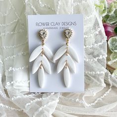 Handmade Polymer Clay Wedding Earrings. Beautiful Lightweight Shimmering White Pearl color with shiny resin finish that makes the sparkle look so stunning and beautiful. Gold plated hardware with cubic zirconia. Approximately 2.7 inches.  Please message for custom bridal and bridesmaid orders. It is so fun to make your visions come to life! White Dangle Earrings For Wedding Gift, Handmade White Chandelier Earrings For Anniversary, Handmade White Teardrop Bridal Earrings, Polymer Clay Wedding, Jewelry Polymer Clay, Boho Crystal, Handmade Jewelry Earrings, Clay Design, Jewelry Earring