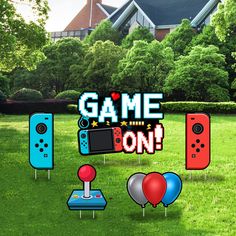 some nintendo wii game controllers and balloons in the grass