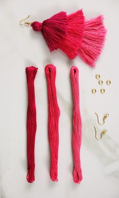 three tassels and two hooks on a white surface