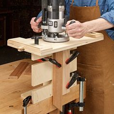 a man using a router on a wooden workbench with tools in his hands