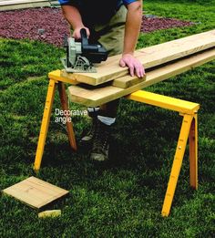 a man sanding down a bench with a power saw