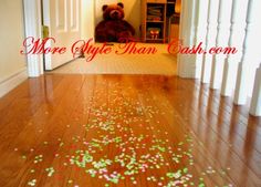 there is confetti on the floor in front of a teddy bear and door