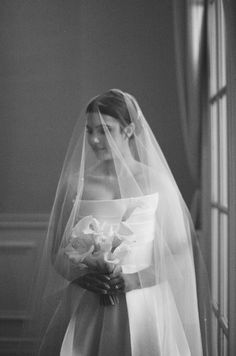 black and white photograph of a bride in her wedding dress with veil over her head