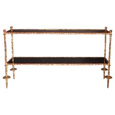 a gold and black shelf with candles on it