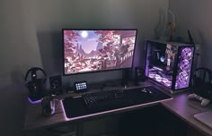 a desk with a keyboard, mouse and monitor on it in front of a wall