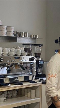 a man standing in front of a coffee machine