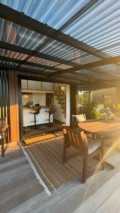 a wooden table sitting under a metal roof