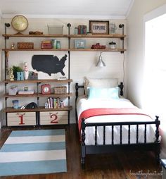 a bed room with a neatly made bed and shelves