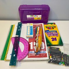 school supplies including pens, pencils, markers and other items are laid out on a table