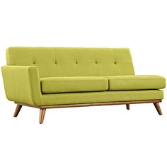 a green couch sitting on top of a wooden frame