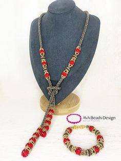 a necklace and bracelet with red beads on a mannequin