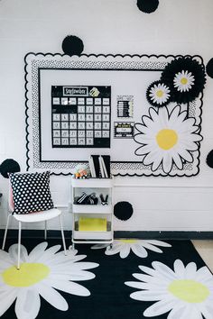 a black and white area rug with flowers on it in front of a wall calendar