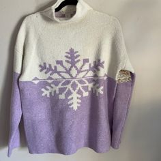 a purple and white sweater with snowflakes on it