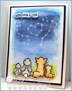 a card with two dogs and a star in the sky on it's side