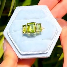 💎 Product Detail: *Metal: 14K Solid Gold *Gemstone:    - **Peridot     - Cut: Emerald-Cut      - Color: Green      - Clarity: Eye-Clean      - Size: 1 Piece 7 x 9 mm, 2 Pieces 5 x 7 mm      - Total Carat Weight (CTW): 5.00 *Diamonds:    - Color: Gold    - Clarity: VS    - Total Carat Weight (CTW): 0.03 💓 Why You'll Love It: The Fortune Olive Green Peridot Three Stone Ring is a stunning blend of vibrant color and timeless elegance. Featuring a central 7 x 9 mm emerald-cut peridot flanked by two 5 x 7 mm emerald-cut peridots, this ring creates a captivating triad of rich green stones. The 14K solid gold band adds a luxurious touch, while the sparkling diamonds enhance the overall elegance of the piece. This ring symbolizes prosperity, harmony, and eternal love, making it an ideal gift for Green Three Stone Peridot Jewelry, Green Peridot Three Stone Jewelry, Green Three Stone Gemstones For Anniversary, Green Citrine Rings With Accent Stones, Green 14k Gold Gemstones With Accent Stones, Green Citrine Gemstone Rings, Green Multi-stone Gemstones In 14k Gold, 14k Gold Green Gemstones, Diamond Three Stone Ring