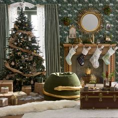 a living room decorated for christmas with stockings on the fireplace