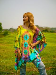 "Indulge in the unique charm of our hand-dyed tunic top, meticulously crafted for those who appreciate exceptional fashion. Made from 100% breathable and comfy rayon, this stunning piece is designed to elevate your style while ensuring absolute comfort. Our tunic top stands out with its one-of-a-kind hand-dyed method, guaranteeing that no two pieces are exactly alike. Embracing a loose silhouette, it offers a versatile fit that flatters a wide range of sizes, from S to 2XL. With its side-stitched closure and convenient armholes, this slipover style tunic top is incredibly easy to wear. A delightful feature of this blouse is the fringes decoration adorning the bottom, adding a touch of bohemian elegance to your ensemble. The tunic top measures up to 60\" in the bust and hip, providing ample Multicolor Kaftan With Natural Dye For The Beach, Bohemian Tie Dye Kaftan With Batik Print, Bohemian Hand Dyed Kaftan For Festivals, Free Size Tie Dye Kaftan For Festival, Summer Festival Multicolor Poncho, Bohemian Batik Print Summer Tunic, Bohemian Tie Dye Spring Kaftan, Spring Bohemian Hand Dyed Kaftan, Multicolor Summer Festival Poncho