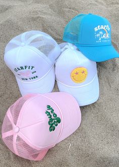 Starfit trucker hats! Offered in 4 styles. Mesh back with adjustable snapback. Terry fabric lines the inside for ultra comfort and sweat wicking. Smiley: white hat with chenille embroidery New York: light pink hat with 3D embroidery Varsity: white hat with embroidery Tropics: teal blue hat with print Pink Trucker Hat Aesthetic, Cute Hats For Summer, Light Blue Trucker Hat, Pink Trucker Hats, Trucker Hat Trendy, Cute Summer Hats For Women, Girls Trucker Hats, Beachy Trucker Hats, Custom Trucker Hats Design