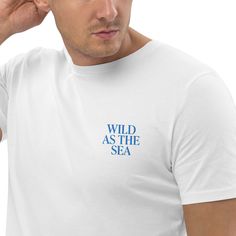 ️ Surfer T-shirt with embroidered "WILD AS THE SEA" lettering on the left chest. 🌊 Minimalist design for water sports, beach, vacation and ocean enthusiasts. Made from 100% organic ring-spun cotton, this unisex t-shirt is a must-have. It's high quality, super comfortable and best of all - environmentally friendly. Material: * 100% ring-spun organic cotton * Fabric weight: 180 g/m² (5.3 oz./yd.²) * Single jersey * Medium fit * Adjusted sleeves * 1 × 1 ribbing on the collar * Wide double seams on White Relaxed Fit T-shirt With Letter Embroidery, Relaxed Fit T-shirt With Embroidered Logo For Summer, Summer Tops With Relaxed Fit And Embroidered Logo, Relaxed Fit Top With Embroidered Logo For Summer, Summer T-shirt With Letter Embroidery And Short Sleeves, Summer Short Sleeve T-shirt With Letter Embroidery, White Embroidered Logo T-shirt For Summer, Summer T-shirt With Embroidered Text And Short Sleeves, Summer Relaxed Fit T-shirt With Embroidered Text