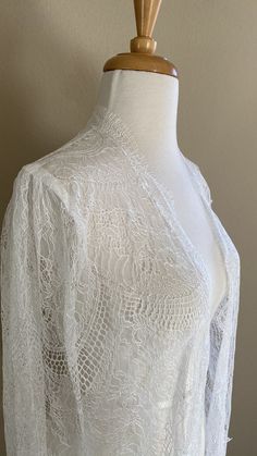 "Chantilly lace cape in off-white shade Unique fabric design with a chandelier-like motif giving an Art Deco vibe Fitted shoulders with soft gathers The cape is edged with eyelash scallop edge - very feminine Finished length is 60\" from shoulders A one-of-a-kind design💕" Delicate Lace Gown For Ceremonies, Ceremony Gown With Delicate Lace, Delicate Lace Robe For Wedding Night, Lace Wedding Night Robe With Lace Sleeves, Lace Dress With Lace Cuffs For Wedding Night, Fitted Robe With Lace Sleeves For Wedding Night, Fitted Wedding Night Robe With Lace Sleeves, Fitted Lace Robe For Wedding Night, Fitted Wedding Robe With Lace Sleeves