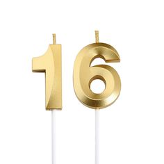 the number sixteen candle has been placed on top of a white stick with gold foil