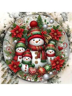 a snowman family with christmas decorations and poinsettis