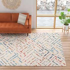 a living room with an orange couch and white rug