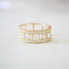 a gold ring with white stones on it