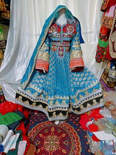 afghan kuchi traditional wedding drees is made of good quality long lasting fabric. Traditionally such Afghanistan Persian Pashtun new design frocks are used as bridal dress. Most of girls also like and recommend such dresses for wedding, Nikkah and Mehndi night events. The dress measurements are kept average. If you need this frock in exact measurements , then please send us measurements which best fit on your body Blue Afghan Dress, Bohemian Shantoon Dupatta For Wedding, Bohemian Wedding Lehenga With Dabka Detailing, Bohemian Wedding Lehenga With Dabka, Anarkali Choli With Dabka Work For Festival, Anarkali Style Choli With Dabka Work For Festivals, Traditional Dabka Work Lehenga For Festival, Anarkali Choli With Dabka For Traditional Ceremonies, Traditional Lehenga With Dabka Work For Festivals