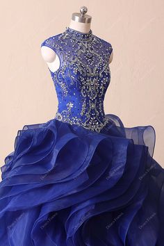 This luxury royal blue quinceanera dress features dazzled crystals illusion high neck bodice with basque waistline. Eye-catching ruffled organza ball gown skirt finishes off the look. shown color: royal blue bra support: build-in-bra boning: yes closure: back zipper lining: partially lined Royal Blue Ball Gown For Quinceanera And Prom Season, Ruffled Organza Quinceanera Dress, Royal Blue Royal Ball Gown For Quinceanera, Fitted Organza Quinceanera Dress, Royal Blue Quinceanera Dress For Prom Season, Royal Blue Quinceanera Dress For Debutante Ball, Royal Fitted Ball Gown For Quinceanera, Royal Blue Ball Gown For Quinceanera, Blue Organza Ball Gown For Quinceanera