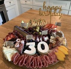 a birthday platter with cheeses, meats and fruit for someone's 50th