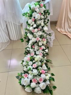 a bouquet of white and pink flowers on the floor