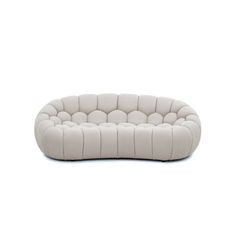 a white couch sitting on top of a white floor