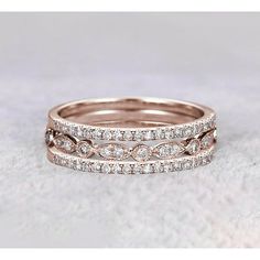 two wedding bands are shown with diamonds on the band and in between them, there is a