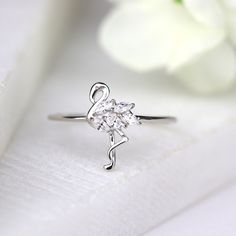 ✩ Made of solid sterling silver and marked 925. Good for sensitive skin. ✩ White gold finish to add extra shine and ensure durability ✩ Finest diamond simulants ✩ Main stone carat weight: 2 ct ✩ Shank width 1 mm ✩ Approx. weight: 1.2 g ✩ Handmade in USA & Ship beautifully packaged We only choose the finest diamond simulants (CZ 5A) on the market, with a breathtaking level of brightness like real diamonds. Our jewelry can be found in stores and boutiques in Illinois, Indiana and Wisconsin. We Elegant Silver Rings For Birthday, Nickel-free Silver Rings For Birthday, Bird Ring, Bird Rings, Tropical Bird, Diamond Simulant, Tropical Birds, Ring Dainty, Dainty Ring