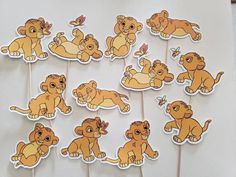 the lion king cupcake toppers are arranged on sticks