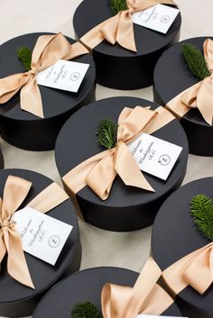 black round boxes with brown bows and tags