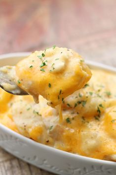 a spoon full of cheesy potato casserole