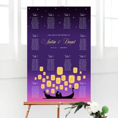 a purple and yellow wedding seating chart on a easel