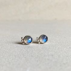 These stunning 'Labradorescence' stud earrings feature labradorite gemstones and sterling silver balls. Labradorite is treasured for its remarkable play of color, known as labradorescence. The stone, usually gray-green, dark gray, black, or grayish-white, is composed of aggregate layers that refract light as iridescent flashes of peacock blue, gold, pale green, or coppery red. These delicate earrings are small but striking due to the nature of the labradorite gemstone. They are perfect to wear e Coppery Red, Peacock Blue, Delicate Earrings, Green Dark, Inner Strength, Recycled Sterling Silver, Pale Green, Gray Green, Jewelry Earrings Studs