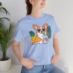 Introducing our Summer Corgi Unisex Graphic Tee – a must-have addition to your warm-weather wardrobe that combines adorable corgi charm with the laid-back vibes of summer! This tee isn't just clothing; it's a fun and stylish way to celebrate your love for these delightful pups and the sunny season. Crafted for both men and women who adore corgis, this tee is perfect for adding a touch of whimsy to your summer look, whether you're lounging at the beach or soaking up the sun by the pool. Featuring a playful corgi graphic and made from high-quality materials for comfort and durability, this tee is sure to become a favorite in your collection. Whether you're a proud corgi lover or searching for the perfect gift for a fellow dog enthusiast, our Summer Corgi Unisex Graphic Tee is guaranteed to b Corgi Graphic, Corgi Shirt, Beach Dog, Sunny Season, Apparel Merchandising, Dog Beach, Dog T Shirt, Summer Break, Dog Tshirt