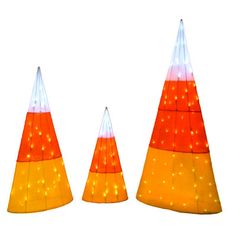 three orange and white cones with lights on them