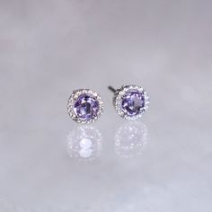 "These stylish earrings have a stunning bright color and the Amethyst is surrounded by a halo of shimmering diamonds. Perfect as a gift for yourself, your girlfriend or wife, or your mother. Features * Made to Order. * Metal: 925 Sterling Silver * Custom Color: Silver, Gold, Rose Gold * Main Stone: Amethyst, 5mm dia Round Shape, 2pcs * Side Stone: Cubic Zirconia Amethyst Ring: * Halo Ring: https://etsy.me/32kkc68 * Bypassing: https://etsy.me/32u2NIF Be sure to hit \"favorite\" on the right so it Purple Cubic Zirconia Round Earrings, Purple Birthstone Earrings Fine Jewelry, Gift Amethyst Jewelry With Halo Design, Purple Halo Jewelry As A Gift, Lavender Halo Setting Jewelry Gift, Fine Jewelry Lavender Earrings As Gift, Purple Gemstones With Halo Setting, Birthstone Engagement Rings, Halo Diamond Earrings