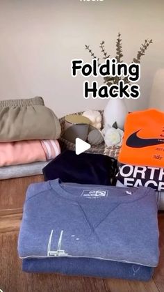 there is a pile of folded clothing on the floor next to a wall with words folding hacks